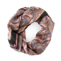 Silk cotton scarf with dusted lavender filigree pattern in coral, gold, and black tones. Illustrated by Lisel Ashlock.