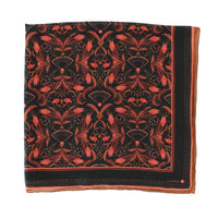 Silk cotton scarf with red and gold damask filigree pattern on black background, bordered in mahogany. Illustrated by Lisel Ashlock.