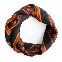 Silk twill scarf in bright mahogany with red and gold filigree patterns arranged in a circle. Illustrated by Lisel Ashlock.