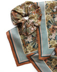 Folded silk twill scarf in midnight hellebore pattern with gathered scrunchie detail. Illustrated by Lisel Ashlock.