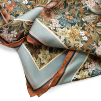 Folded silk twill scarf in midnight blue with botanical floral pattern and copper trim. Illustrated by Lisel Ashlock.
