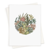 Botanical illustration of succulents, cacti, and desert flowers arranged in a circle on a blank greeting card. Illustrated by Lisel Ashlock.