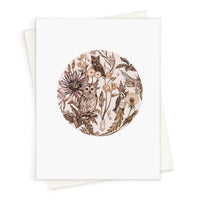 Blank greeting card featuring a circular illustration of owls and botanical elements in sepia tones. Illustrated by Lisel Ashlock.