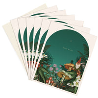 A fanned stack of holiday greeting cards featuring woodland gnomes among mushrooms and botanicals with "Peace & Love" text. Illustrated by Lisel Ashlock.