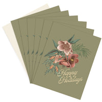 A stack of sage green greeting cards featuring illustrated hellebore flowers with "Happy Holidays" text, illustrated by Lisel Ashlock.