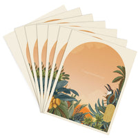 A fanned stack of cream-colored congratulations greeting cards featuring botanical illustrations and a warm sunset circle. Illustrated by Lisel Ashlock.