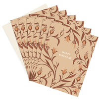 Stack of Happy Birthday greeting cards with peach and brown floral pattern on tan background. Illustrated by Lisel Ashlock.
