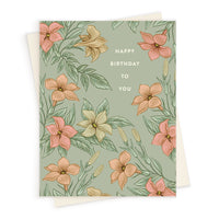 Birthday greeting card with sage green background featuring pink, peach, and cream flowers with green foliage and white text reading "Happy Birthday to You." Illustrated by Lisel Ashlock.