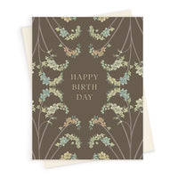 Happy Birthday greeting card with hanging blue and green flowers on taupe background. Illustrated by Lisel Ashlock.