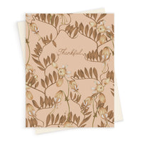 Greeting card with "Thankful" text surrounded by botanical illustration of wild bramble branches in warm earth tones. Illustrated by Lisel Ashlock.