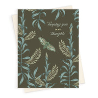 A sympathy greeting card with botanical illustrations and a moth on olive green background. Illustrated by Lisel Ashlock.