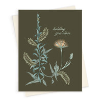 Greeting card with botanical illustrations and "holding you close" text on olive background. Illustrated by Lisel Ashlock.