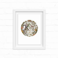 A circular illustration of a guereza monkey surrounded by botanical elements in an ornate frame, illustrated by Lisel Ashlock.