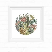 A circular arrangement of succulents, cacti, and desert flowers in muted greens, pinks, and golds. Illustrated by Lisel Ashlock.
