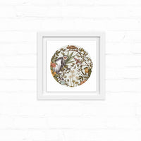 Circular botanical illustration featuring a guereza monkey among flowering plants and foliage in earth tones, framed in white. Illustrated by Lisel Ashlock.