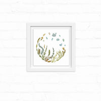 Watercolor illustration of wildflowers and grasses arranged in a circular wreath with floating leaves above, framed in white. Illustrated by Lisel Ashlock.