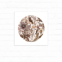 Circular botanical illustration featuring owls and birds among flowers and foliage in sepia tones. Illustrated by Lisel Ashlock.