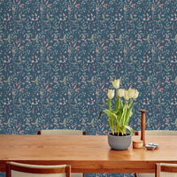 Sonoma Wallpaper in indigo with botanical pattern behind wooden table with yellow tulips. Illustrated by Lisel Ashlock.