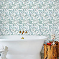 Luxurious bathroom with Atoll Wallpaper in marine, freestanding white bathtub, and wooden side table. Illustrated by Lisel Ashlock.