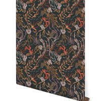 Coral-colored atoll-inspired wallpaper with botanical sea life patterns on dark background. Illustrated by Lisel Ashlock.