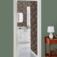 Bathroom doorway with Atoll Wallpaper in coral pattern, green walls, and wood furniture. Illustrated by Lisel Ashlock.