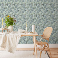 Modern dining space with Secret Garden Wallpaper in robin egg color, wooden furniture, and botanical accents. Illustrated by Lisel Ashlock.