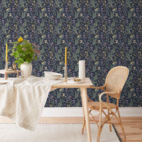 Secret Garden Wallpaper in amethyst featuring ferns and florals on a dining room wall. Illustrated by Lisel Ashlock.