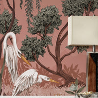 Night Heron Mural in Carnelian features white herons beneath leafy trees against a dusty rose background. Illustrated by Lisel Ashlock.