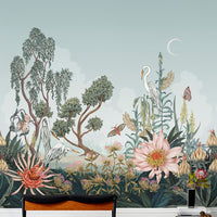 A botanical mural wallpaper featuring herons, flowering plants, trees, butterflies and crescent moon against a sage green sky. Illustrated by Lisel Ashlock.