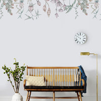 Nursery room with wooden crib, white head vase, hanging plant, clock, floor lamp, and Canopy Mural wallpaper. Illustrated by Lisel Ashlock.