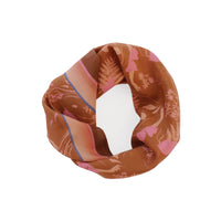 Terracotta and pink patterned silk cotton scarf looped in a circle against white background. Illustrated by Lisel Ashlock.