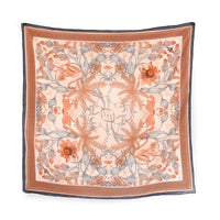 Square silk cotton scarf in sunstone with botanical and animal motifs in orange and gray. Illustrated by Lisel Ashlock.