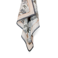 Folded silk cotton scarf in cream with botanical illustrations in gray, tan, and charcoal featuring insects and foliage. Illustrated by Lisel Ashlock.